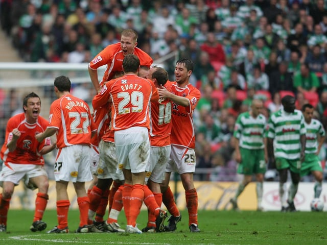 The Blackpool squad celebrate.