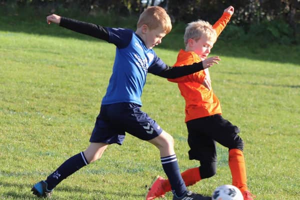 Players from YMCA Orange and Elswick & Inskip Blues battle for the ball Picture: Karen Tebbutt