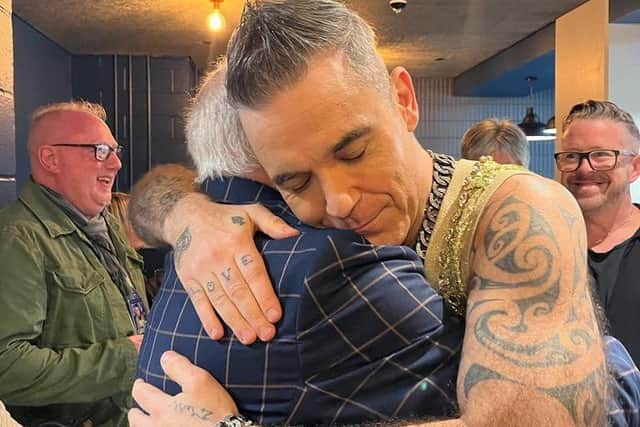 Robbie Williams pictured hugging Blackpool favourite Tommy Cannon, half of legendary duo Cannon and Ball.