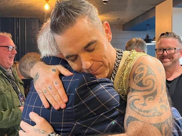Robbie Williams pictured hugging Blackpool favourite Tommy Cannon, half of legendary duo Cannon and Ball.