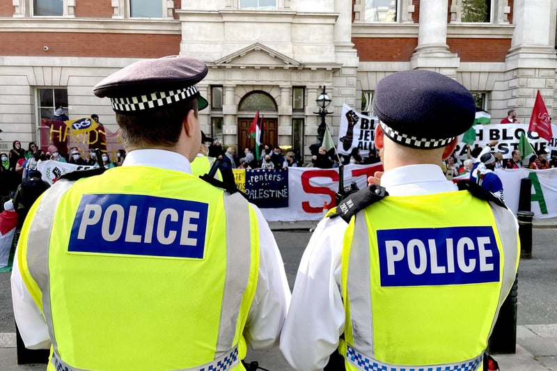 Police look on as protesters gather outside the Business and Trade department in London to show solidarity with Palestine, as they campaign against military arms being manufactured in the UK and sent to Israel.