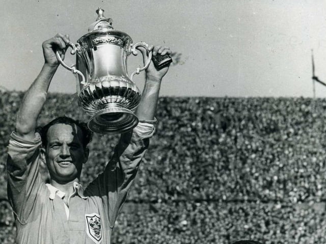 Harry Johnston hoists the FA Cup aloft on the shoulders of Stan Mortensen