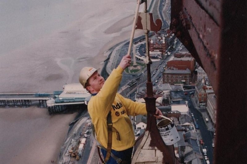 Rigger Mark Smith painting the blue top of the Tower gold for its centenary in 1994. Painting the Tower structure from top to bottom, including replacing corroded steelwork, takes approximately seven years