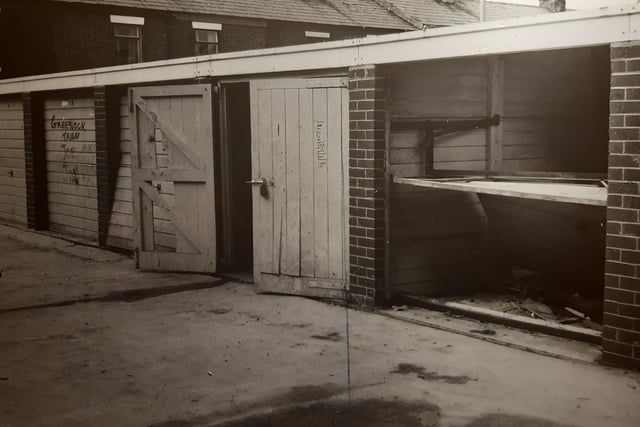An undated photo of garages at the back of Walmsley Street