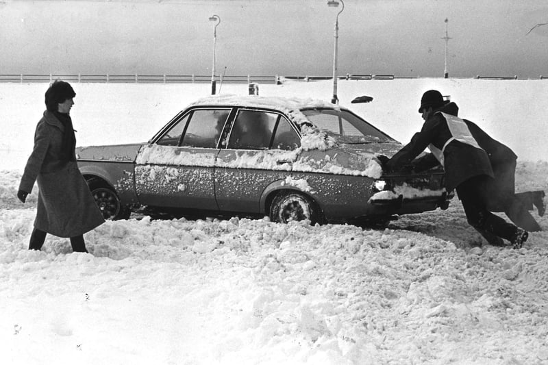The police go to the aid of a stranded motorist on the seafront following heavy snow in 1982