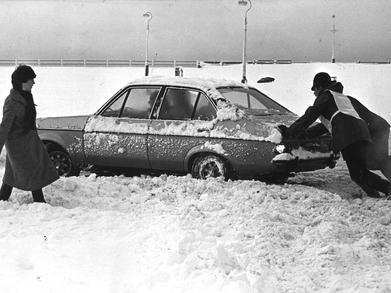 The police go to the aid of a stranded motorist on the seafront following heavy snow in 1982
