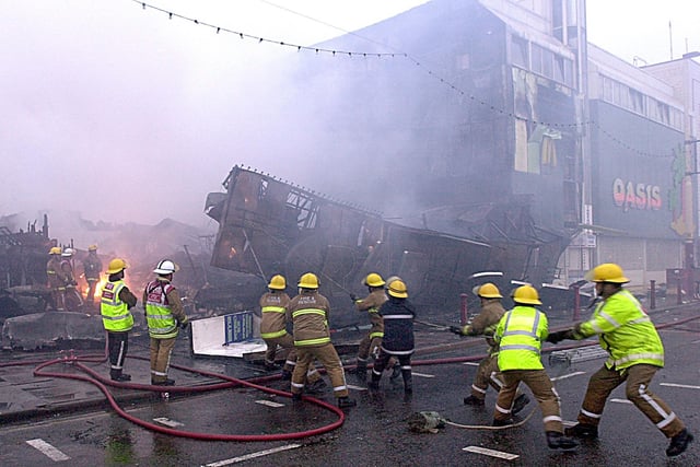 Firefighters at the scene trying to stabilise the main Grab City sign