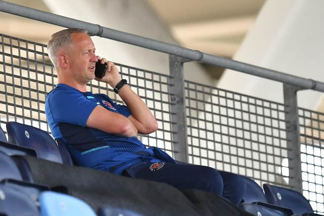 Neil Critchley will make sure his phone stays with him during his family holiday this summer