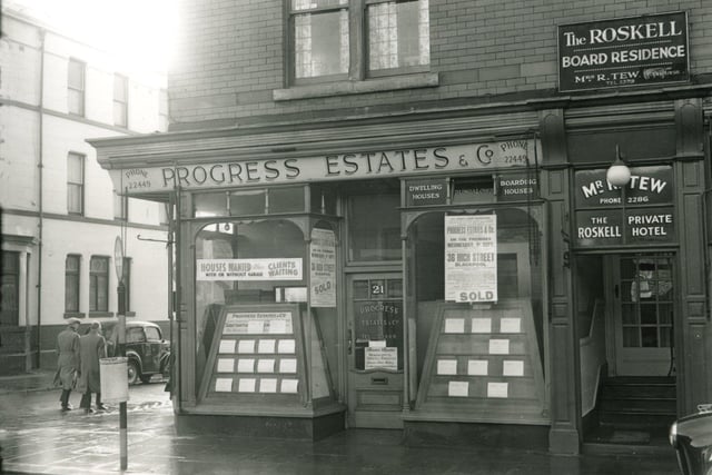 Progress Estates & Co on the corner of Cedar Square and Wood Street with the Cedar Tavern just in view on the left. Next to the estate agents is the entrance to the Roskell Private Hotel