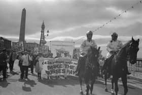 Mounted police lead a demonstration in support of a proposed 4.26 pound per hour minimum wage during the Trades Union Congress conference