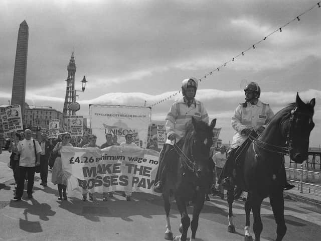 Mounted police lead a demonstration in support of a proposed 4.26 pound per hour minimum wage during the Trades Union Congress conference
