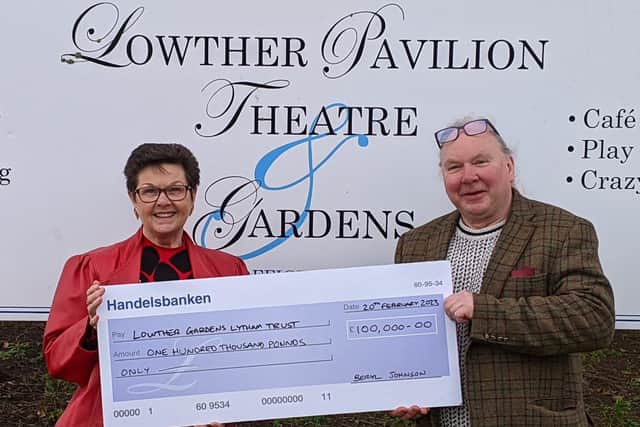 Beryl Johnson presents the £100,000 cheque to Lowther's Tim Lince.