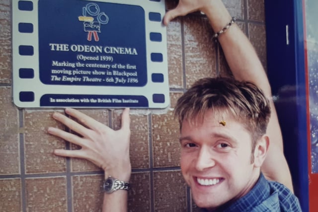 Darren Day with a plaque pinned to the wall at the Odeon commemorating the centenary of the first moving picture show in Blackpool in 1896 at the Empire Theatre