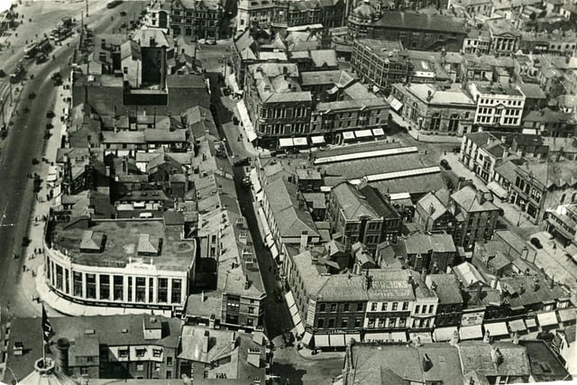 Aerial view from Blackpool Tower looking North. Market Street ( in the centre ) runs parallel with the Promenade and Corporation Street on the right.The long roofs of the old St John's Market and Boots Chemist are in the centre with the town hall and Yates's Wine Lodge are at the top. H Samuel is in the same position as today, on the corner of Church Street and Bank Hey Street Also on church street are Alexandre taylors, Parker's Restaurant and cafe and Dicks shoes