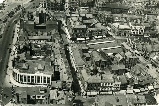 Aerial view from Blackpool Tower looking North. Market Street ( in the centre ) runs parallel with the Promenade and Corporation Street on the right.The long roofs of the old St John's Market and Boots Chemist are in the centre with the town hall and Yates's Wine Lodge are at the top. H Samuel is in the same position as today, on the corner of Church Street and Bank Hey Street  Also on church street are Alexandre taylors, Parker's Restaurant and cafe and Dicks shoes