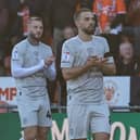 Blackpool's Albie Morgan and Barnsley's Adam Phillips are joined by the players, officials and fans of both sides in clapping in remembrance of Steve Bruce's grandson  Picture: Lee Parker/CameraSport