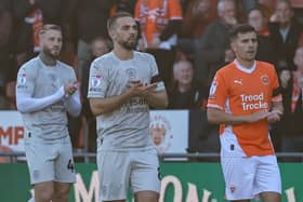 Blackpool's Albie Morgan and Barnsley's Adam Phillips are joined by the players, officials and fans of both sides in clapping in remembrance of Steve Bruce's grandson  Picture: Lee Parker/CameraSport
