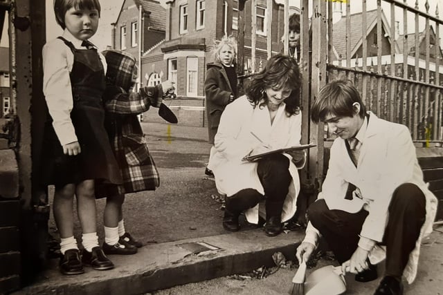 Diane and Denise Brewster, who lived in Seacrest Avenue, watch Brian price taking a dust sample outside Claremont School in October 1982. It was all part of a national survey to monitor pollution outside schools.