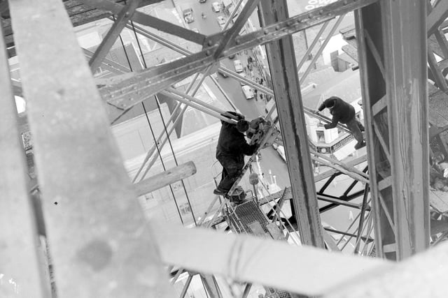 Workmen are seen here on the rods between the huge girders in 1958