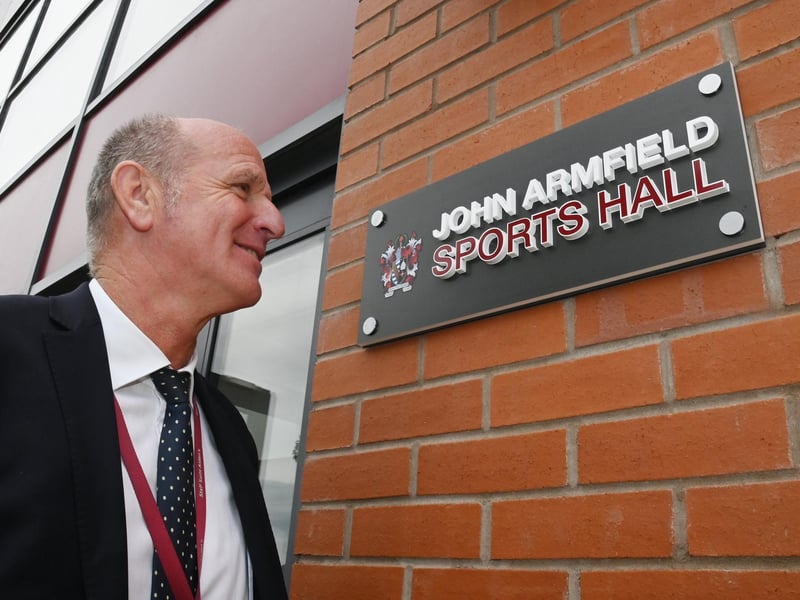The retiring PE school teacher standing by the entrance