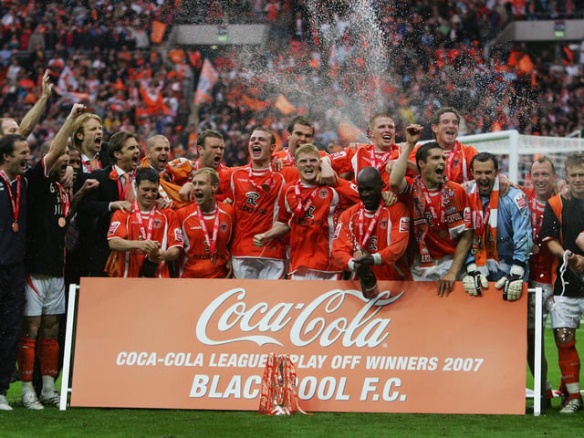 The Blackpool squad celebrate.