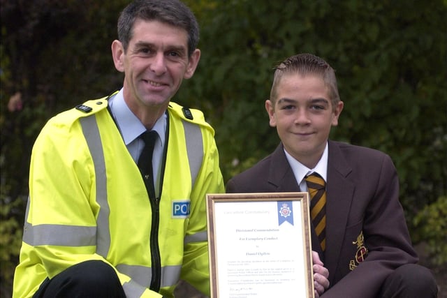 Baines High School pupil Daniel Ogilvie receiving his special police award, for helping to find a stolen handbag, from PC Derek Snalam