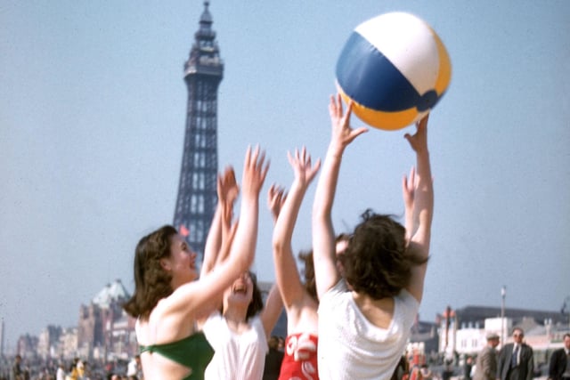 A group of young women play with a beach ball on Blackpool beach in June 1955