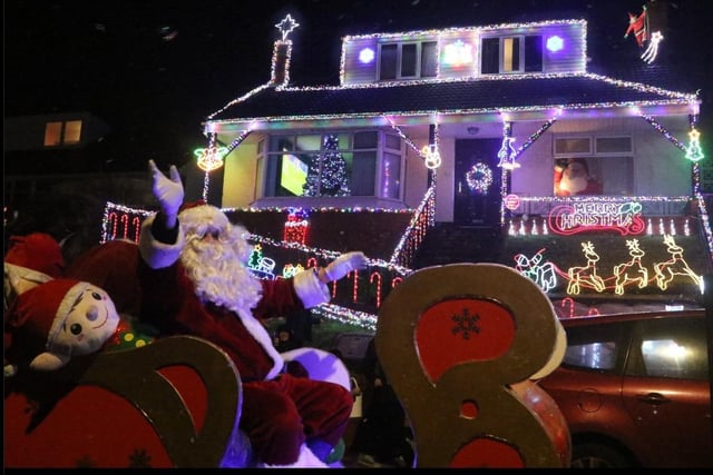 Santa's sleigh - with elf on board - passes Adrian Moore's festively-illuminated home on Beaufort Avenue, Bispham. Photo: Steve Eaves