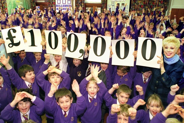 Director of Fundraising Ramesh Gandhi and Deputy director of Macmillan, Elaine Fossett, celebrates reaching the £100,000 mark with children from Lytham Hall Park Primary School