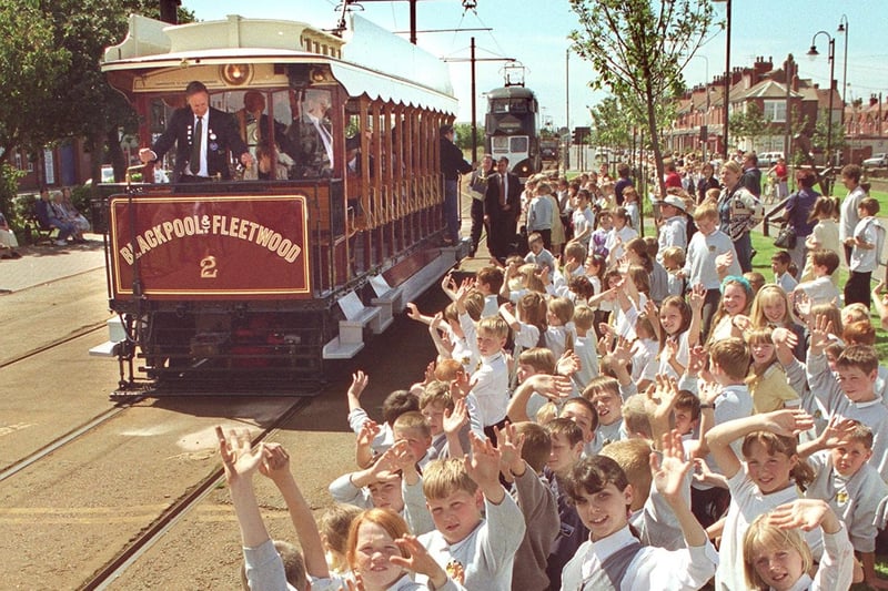 Re-enactment of first tram trip from Blackpool to Fleetwood. Children from Chaucer Primary School, Fleetwood  greet the tram on Fishermans Walk