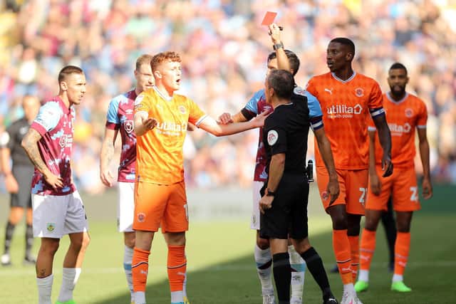 Keith Stroud brandishes a straight red card during Saturday's draw against Burnley