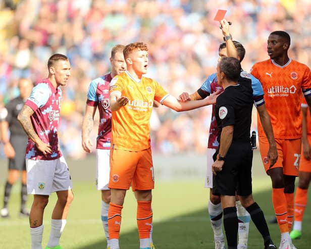 Keith Stroud brandishes a straight red card during Saturday's draw against Burnley