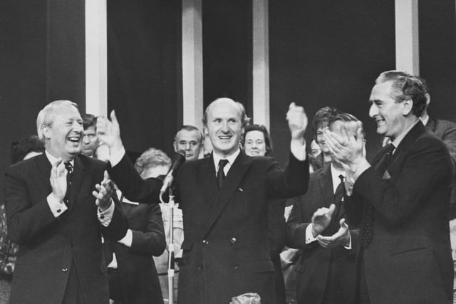Anthony Barber who was the Chancellor of the Exchequer in 1970, receives an ovation after his pledge to reduce taxes. He is flanked by Prime Minister Edward Heath (left) and Party chairman Peter Thomas