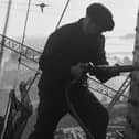23rd February 1937:  A riveter carrying out repairs to the Blackpool Tower in preparation for the coming holiday season