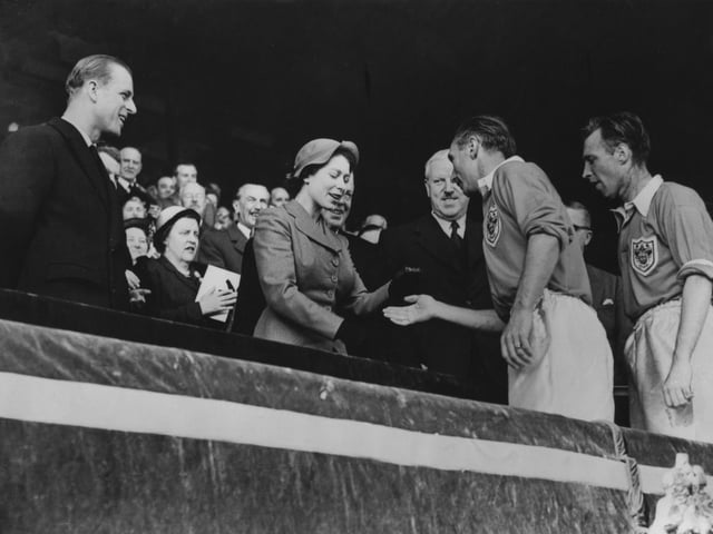 Stanley Matthews receives his winner's medal from The Queen