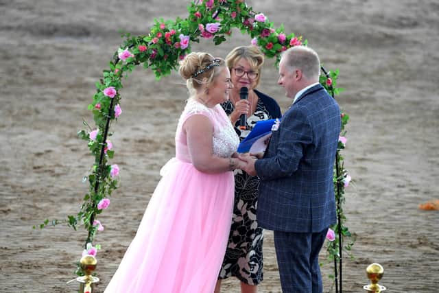 Louise Wiltshire and Shaun McGilloway are married on St Annes beach by celebrant Karen Harrison. Picture: Neil Cross.