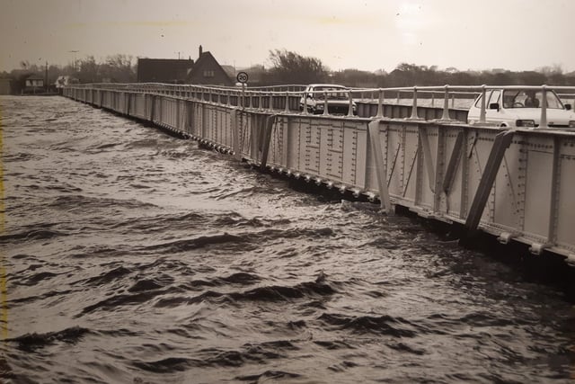 The high tide rises to a dangerous level at Shard Bridge as the traffic continues to flow over the Wyre in February 1990