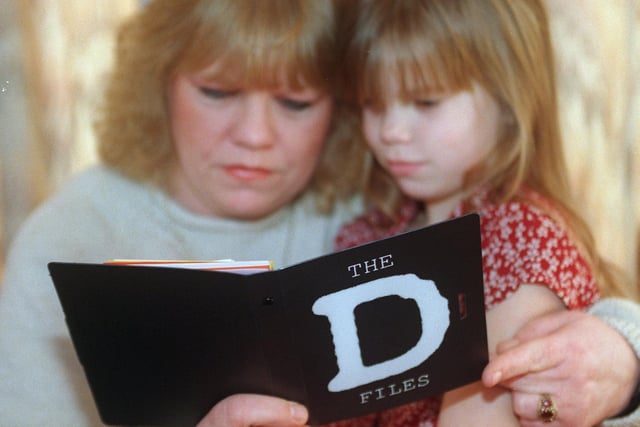 Grange Park mum Lorraine Cribbon with daughter Jolene study the files which is an anti drugs booklet distributed to children on the estate, 1997