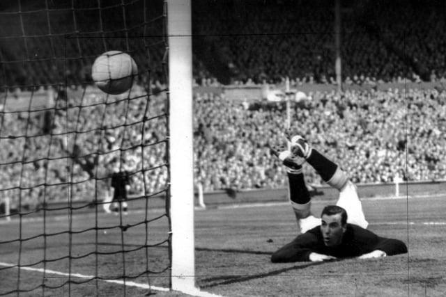 George Farm, the Blackpool goalkeeper, sprawls on the ground as Nat Lofthouse gives Bolton a second-minute lead
