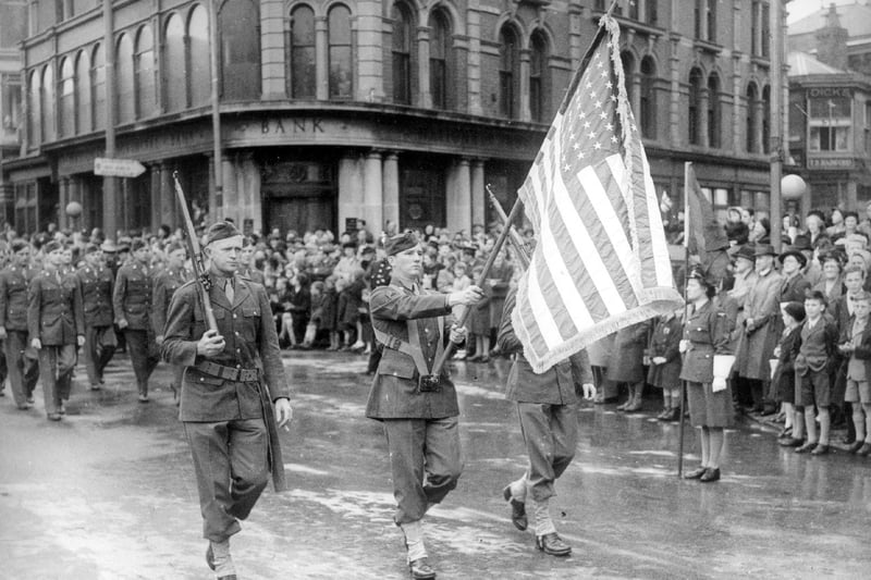 The Stars & Stripes flutter proudly as American troops march in Talbot Square