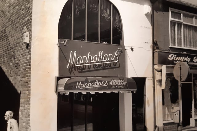 Manhattan's was an American style restaurant on Deansgate. This was in 1988. In the caption on the back of the photo is says it sold cocktails in frosted glasses with a sugared rim and crushed ice made in an American blender...