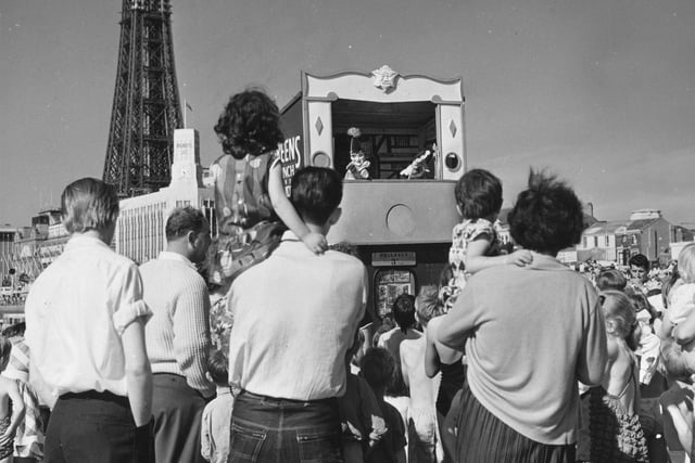 Holiday makers watching a family favourite Punch and Judy show in 1960