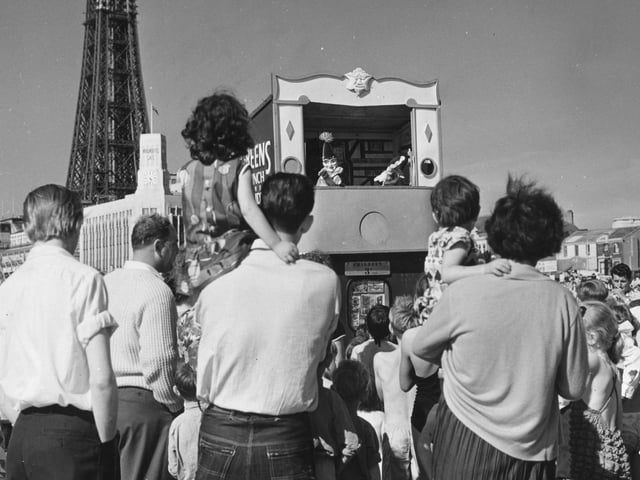Holiday makers watching a family favourite Punch and Judy show in 1960