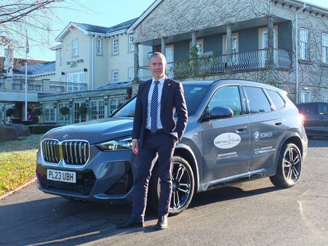 Ribby Hall Director of HR, Estate Maintenance and Safety, John McIlwham with new BMW iX1. Photo:  Bowker BMW