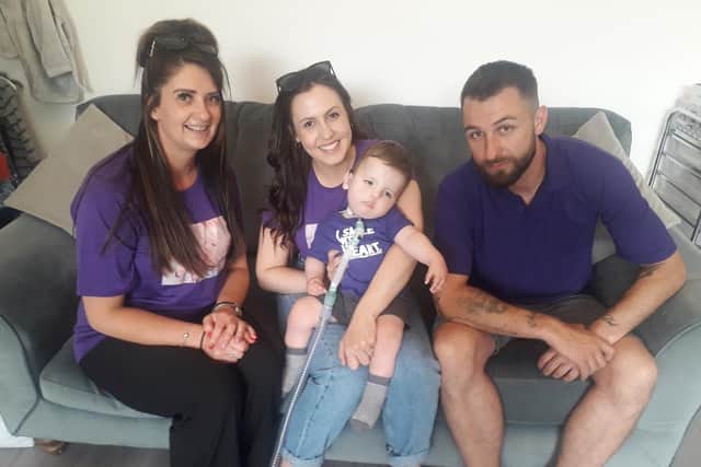 Carer Charlotte Redford (left) with  Teddy Wood and parents Amber Nuttall and Carl Wood