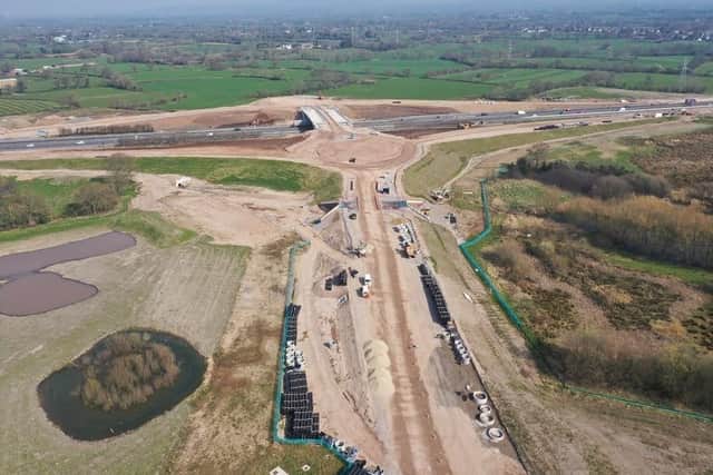 The latest photographs show progress with the ‘dumb-bell’ arrangement featuring a roundabout on each side of the motorway to serve the new slip roads. (Credit: National Highways)
