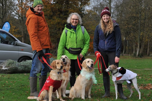 BLACKPOOL - 04-12-22  Dogs and their owners take part in Walkies for Wards, a festive dog walk raising funds for Blue Skies Hospital Funds, a charity for Blackpool Teaching Hospitals, held in the grounds of Lytham Hall, Lytham.  from left, Ian Scarborough, Diane Scarborough and Lucy Scarborough with their four-legged friends.