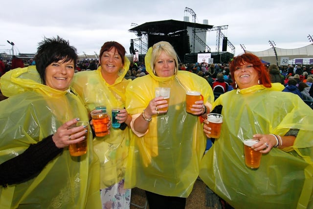 Denise Brown (left) and friends sporting their rain gear ahead of the concert