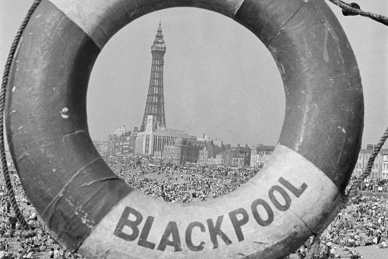 Captured in the 1940s, this life ring frames a packed Blackpool beach. Picture credit: John Gay/Historic England/Mary Evans