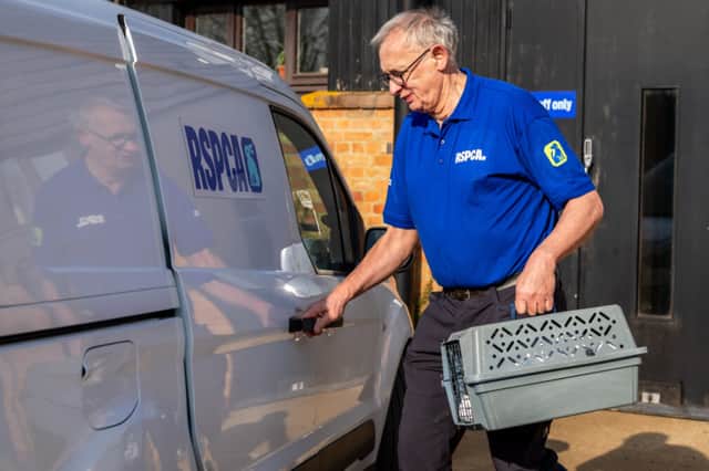 RSPCA Inspector Geoffrey Edmond with a cat carrier and van